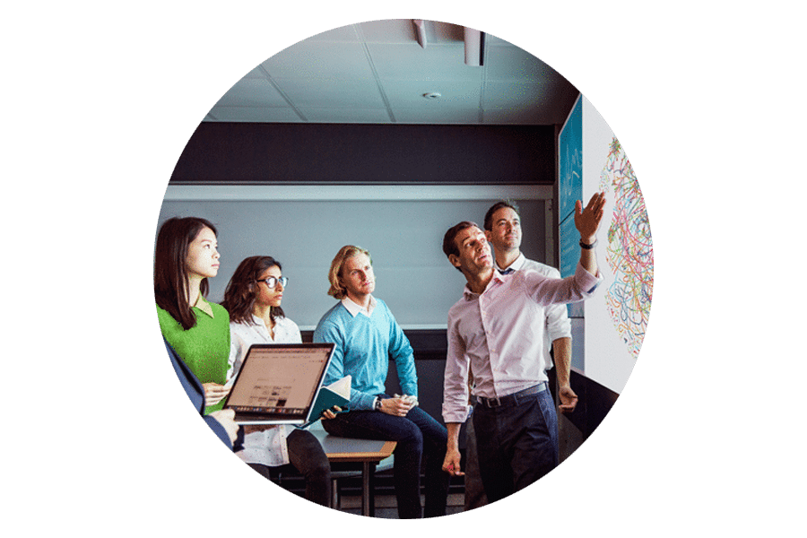 Roundel image of people looking at map - PacBio DevNet round image - PacBio